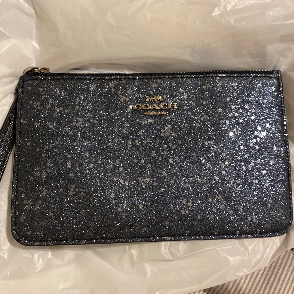 navy Coach wristlet with silver detailing.